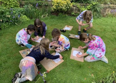 children doing art in garden