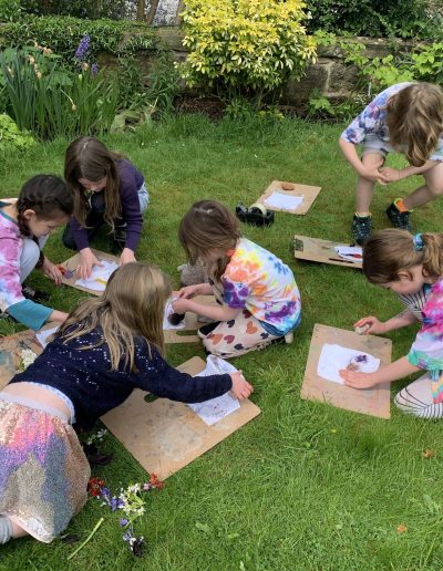 children doing art in garden