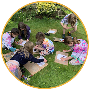 children doing art in garden